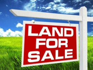 land with 4-sale sign